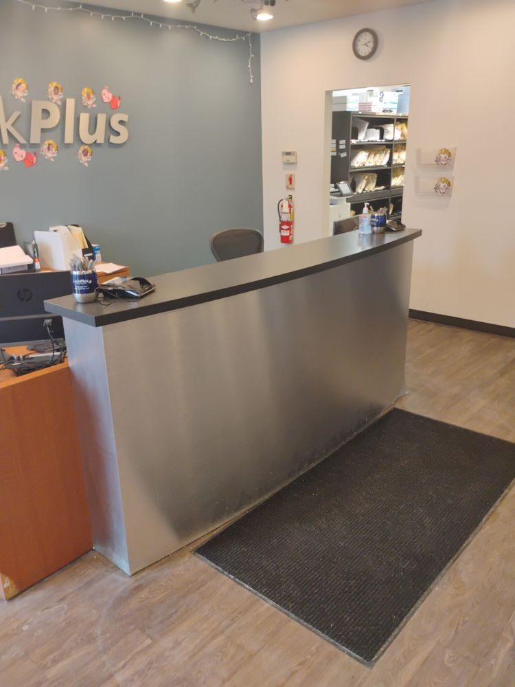 A stainless steel front service counter installed in a business reception area.